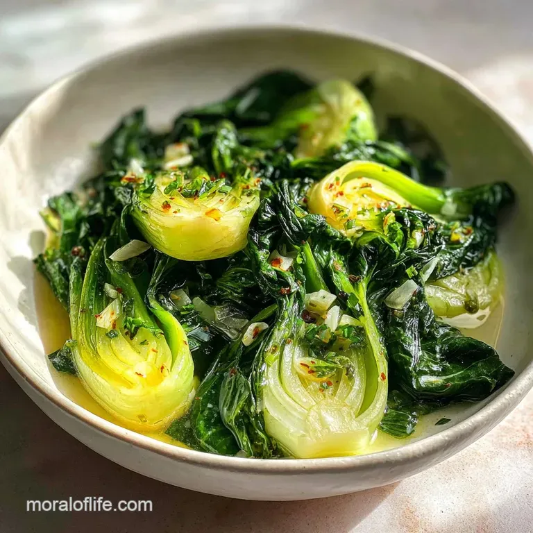 Steaming bok choy spears artfully arranged on a white plate, showcasing their dark green leaves and pale, crisp stems.
