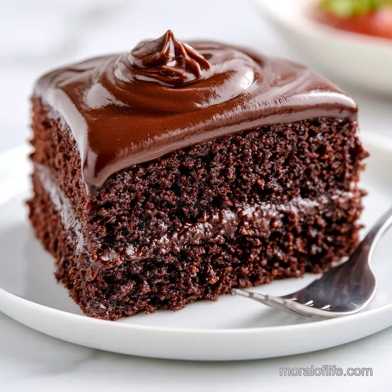 A decadent wedge of dark chocolate cake topped with a single red raspberry and a dusting of powdered sugar.